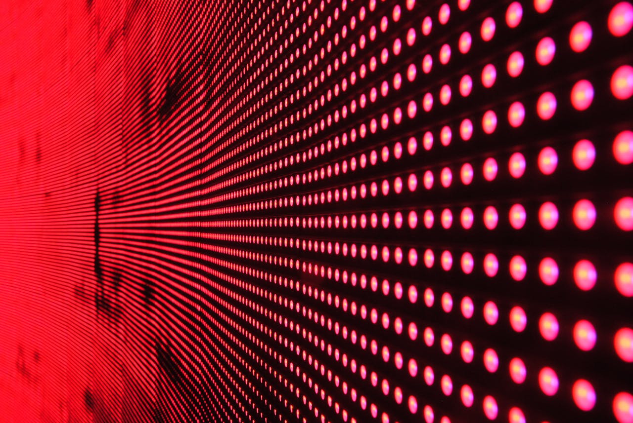 gallery-03 Vibrant abstract pattern of illuminated red LED lights forming a dynamic design.